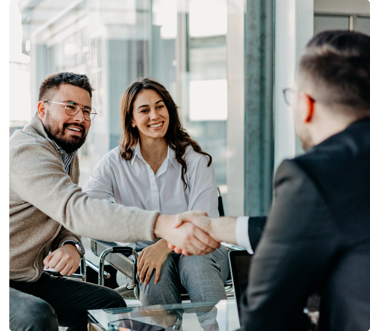 Colleagues greeting with handshake and smiles