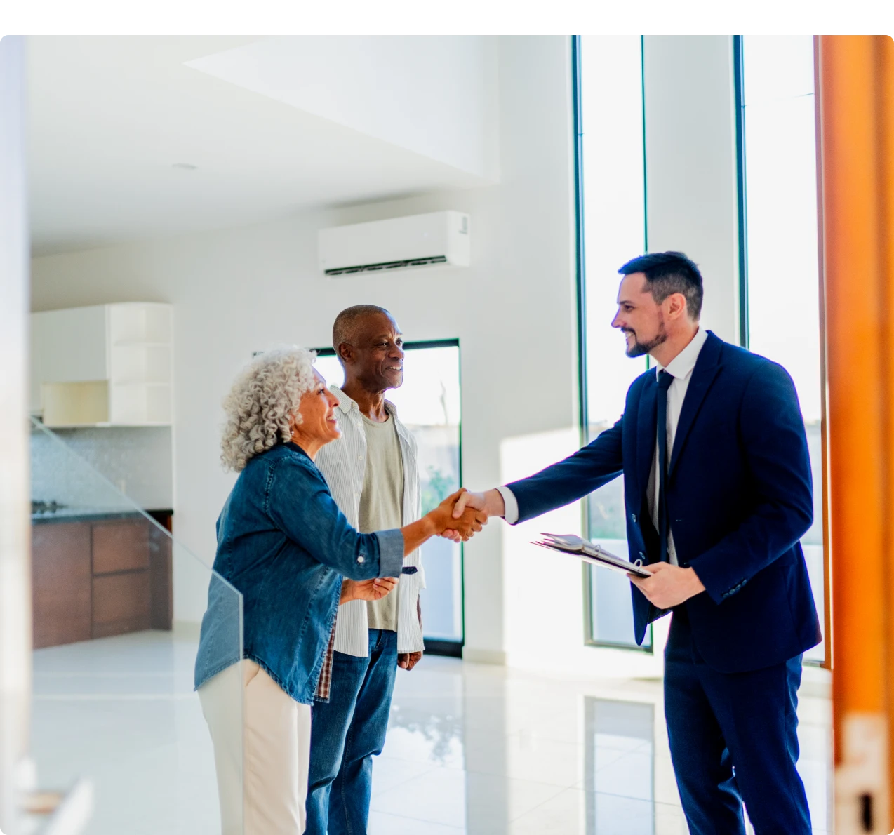 Couple meeting realtor in modern apartment