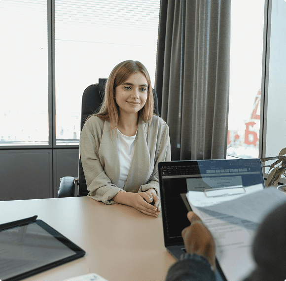 Businesswoman sitting at desk with colleagues